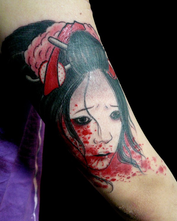 Stunning designed and painted Asian geisha bloody head tattoo on arm