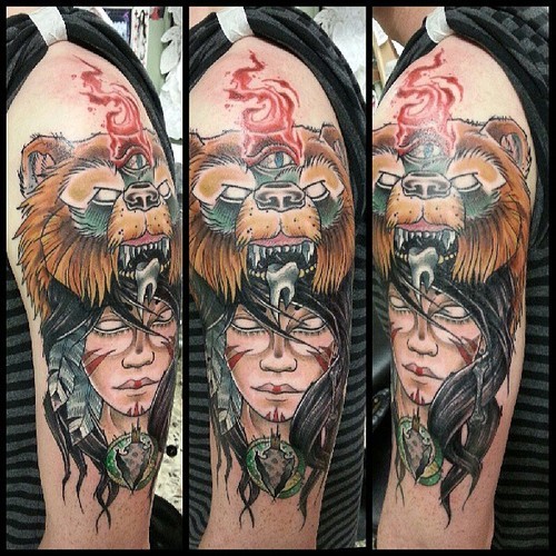 Stunning looking illustrative style colored shoulder tattoo of mystic woman with bear shaped helmet