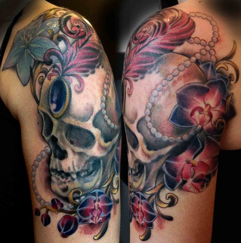 Stunning multicolored shoulder tattoo of human skull with flowers and jewelries