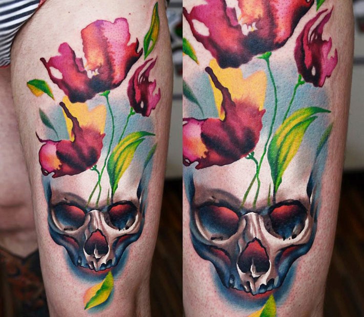 Stunning multicolored thigh tattoo of demonic skull and flowers