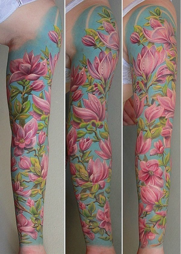 Stunning natural colored sleeve tattoo of pink flowers with leaves