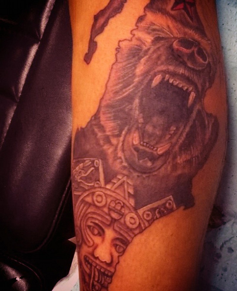 Stunning natural looking black and white roaring bear tattoo combined with Mayan tablet