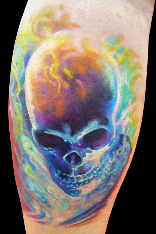 Stunning painted and colored big burning skull tattoo on leg