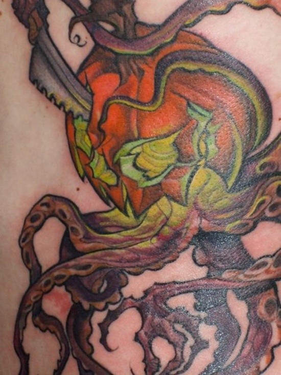 Stunning painted and colored corrupted pumpkin with knife and octopus tentacles tattoo on back