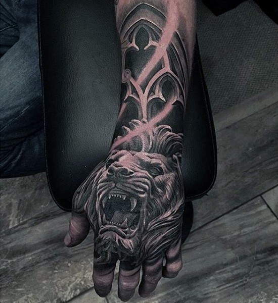 Stunning painted realistic looking roaring lion tattoo on hand