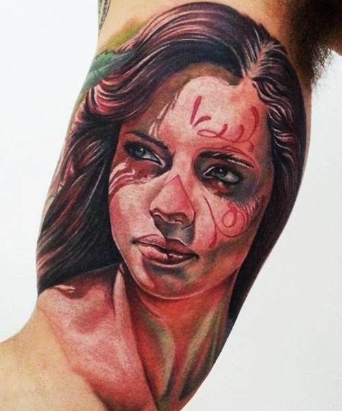 Stunning portrait style colored biceps tattoo of woman portrait