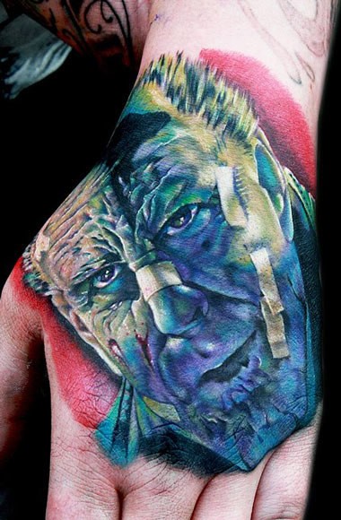 Stunning realistic looking colored hand tattoo of famous movie hero face