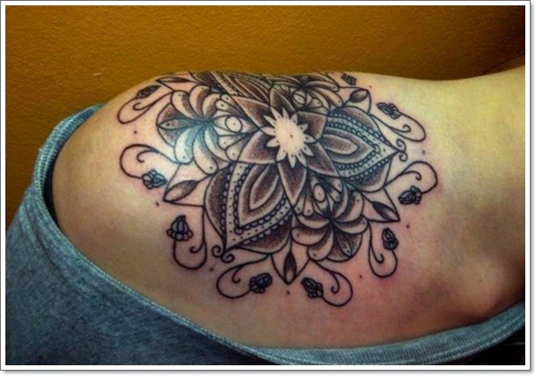 Stylized black lotus tattoo on shoulder