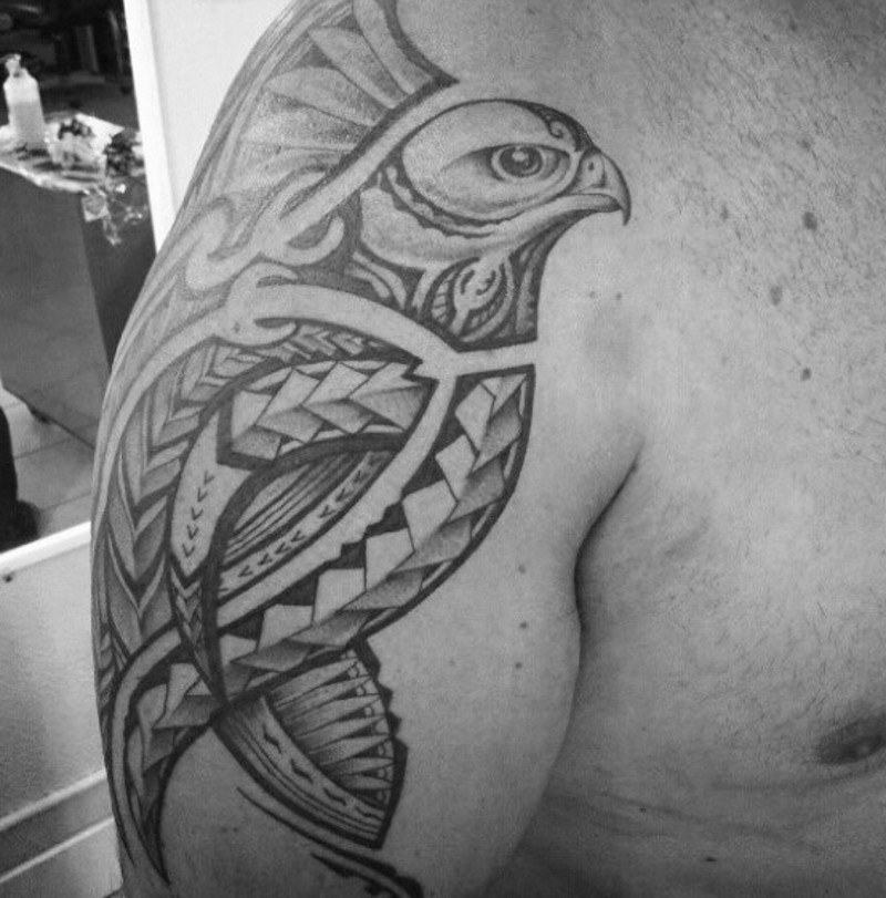 Stylized eagle bird tattoo on shoulder in Polynesian tribal style