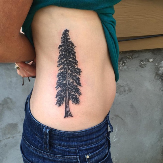 Super detailed and realistic pine tree tattoo on woman's side