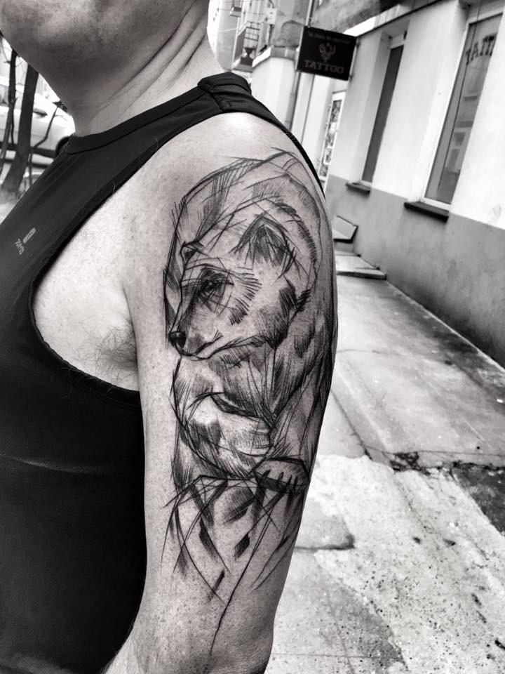 Superior black ink upper arm tattoo of large bear