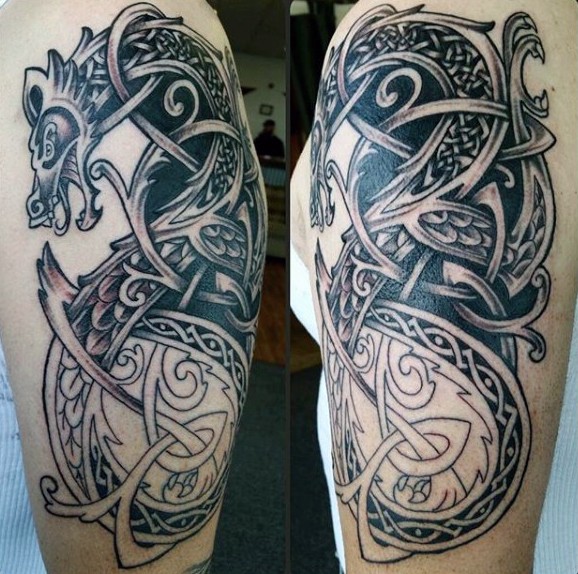 Superior painted Celtic style dragon shaped tattoo on arm