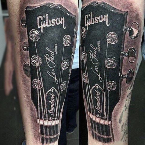 Superior painted very realistic looking black and white Gibson guitar tattoo on arm