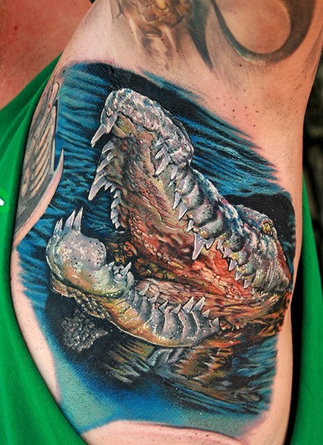 Superior very realistic detailed and colored big alligator tattoo on chest