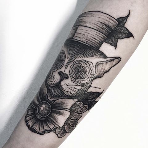 Surrealism like dot style arm tattoo of mystical cat with funny hat and bow