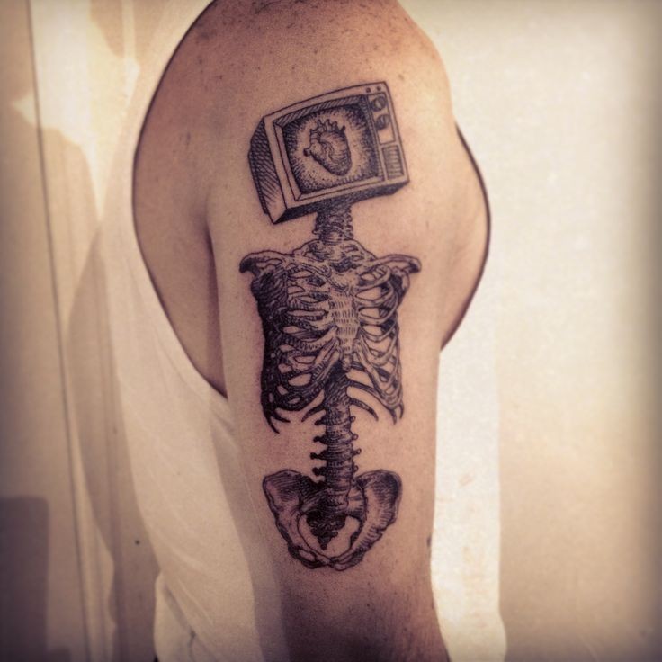 Surrealism style black and white shoulder tattoo of human skull with TV instead of head