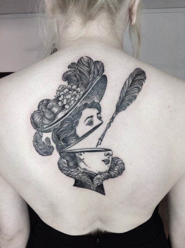 Surrealism style black and white upper back tattoo of woman head with feather