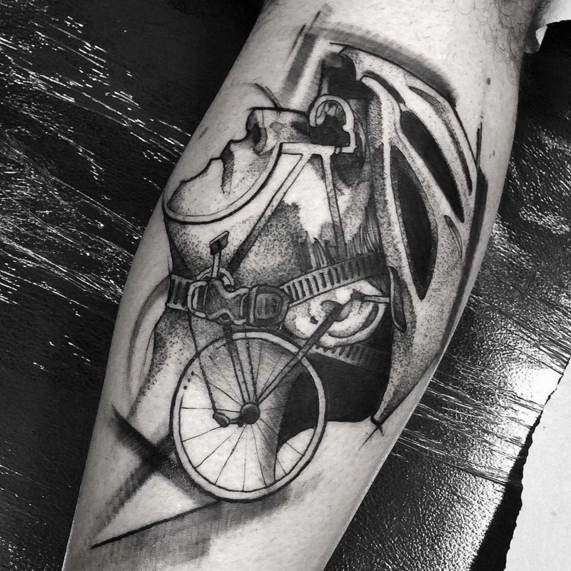Surrealism style black ink arm tattoo of man with bicycle helmet and parts