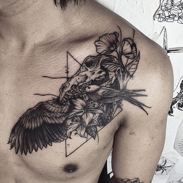 Surrealism style black ink chest tattoo of animal skull with birds and flowers