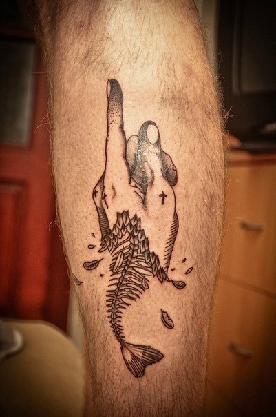 Surrealism style black ink leg tattoo of human hand with fish skeleton