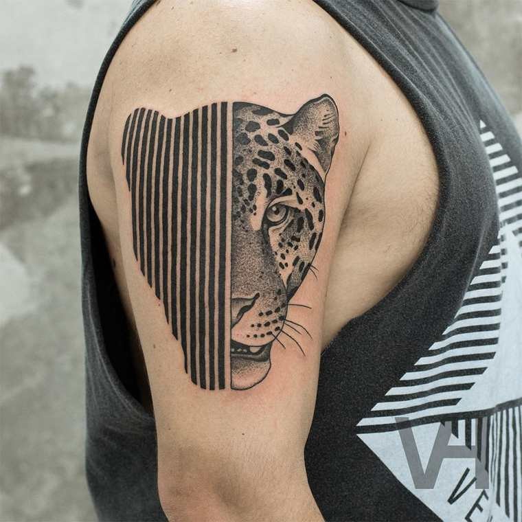 Surrealism style black ink shoulder tattoo of half leopard half lines