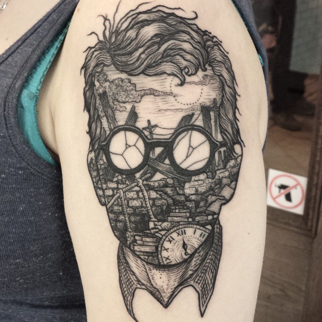 Surrealism style black ink shoulder tattoo of creepy man in sun glasses
