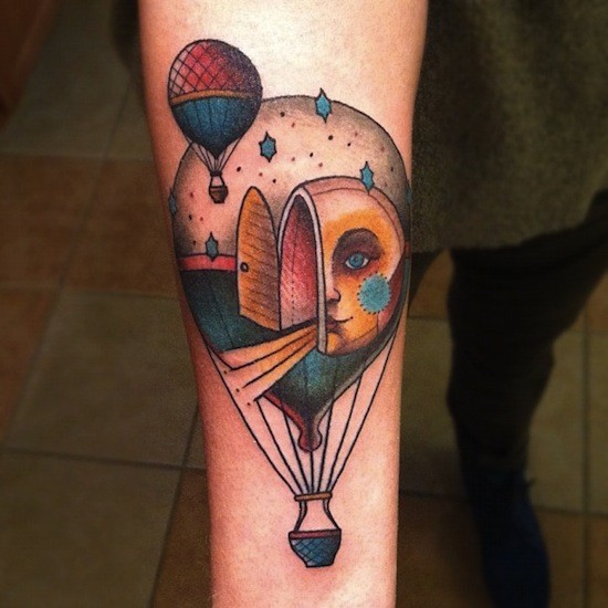 Surrealism style colored arm tattoo of flying balloon