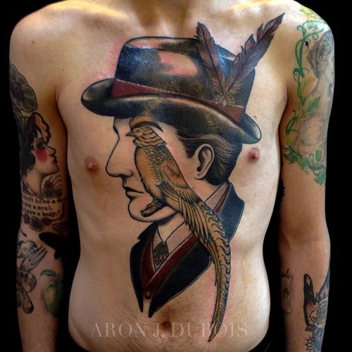 Surrealism style colored chest and belly tattoo of man with parrot
