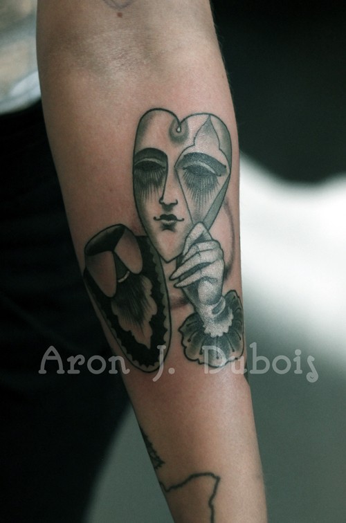 Surrealism style colored forearm tattoo fo heart shaped mask with hand