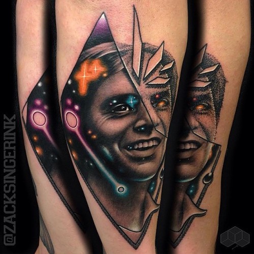 Surrealism style colored forearm tattoo of man face and stars