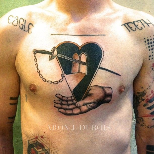 Surrealism style colored heart with sword and human arm
