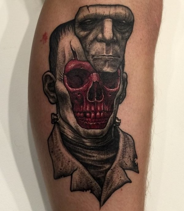 Surrealism style colored leg tattoo of Frankenstein monster face