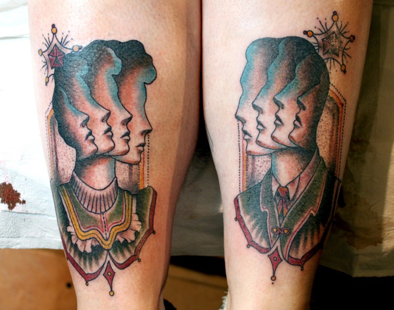 Surrealism style colored legs tattoo of human and woman faces
