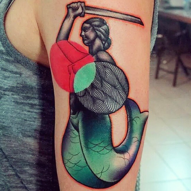 Surrealism style colored shoulder tattoo of mermaid with sword