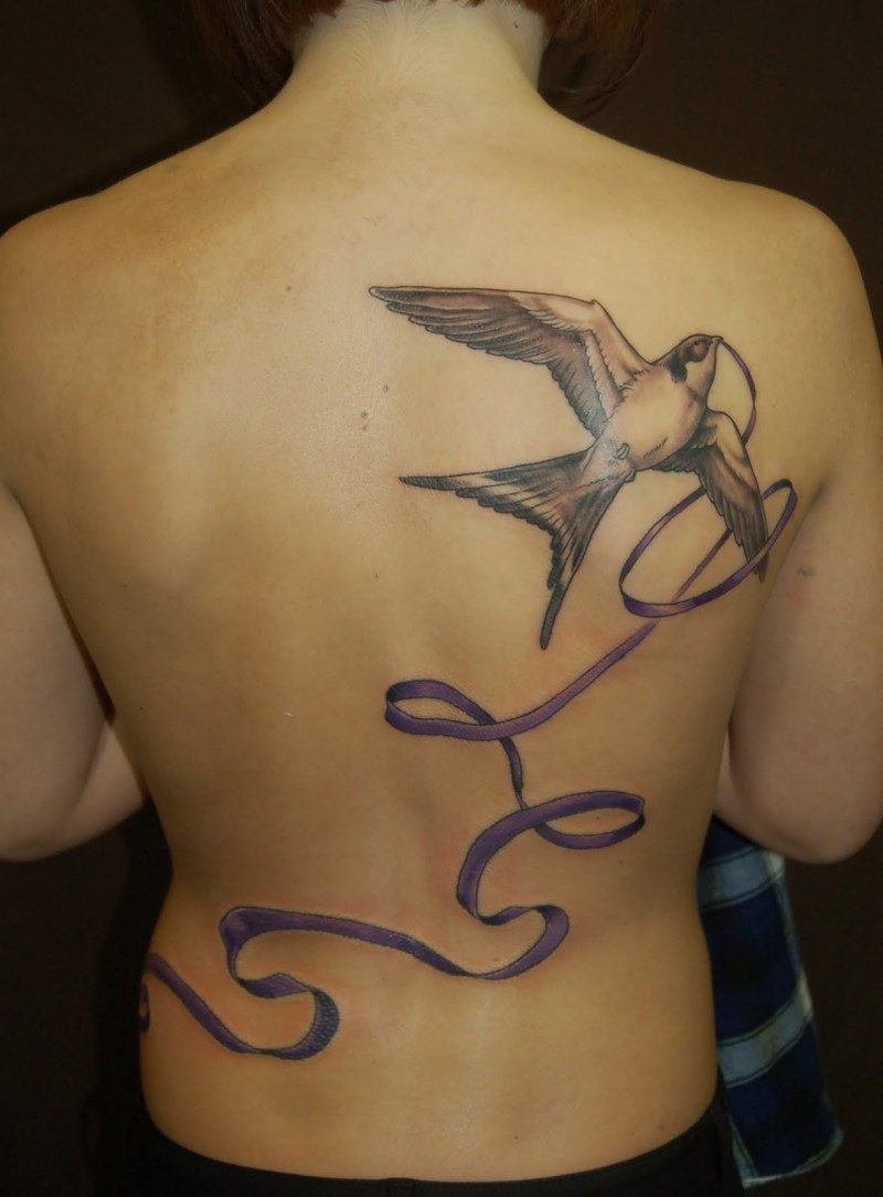 Swallow bird tattoo with purple ribbon
