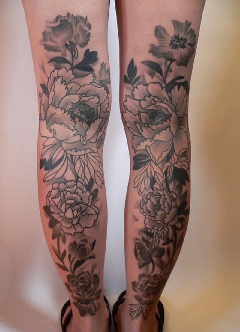 Sweet black ink detailed flowers tattoo on legs