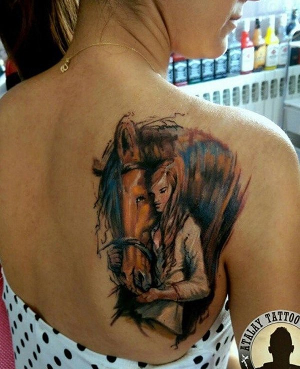 Sweet colored natural looking shoulder tattoo of woman with horse