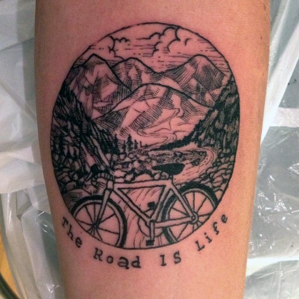 Sweet designed black ink mountain road with bicycle and lettering tattoo on arm