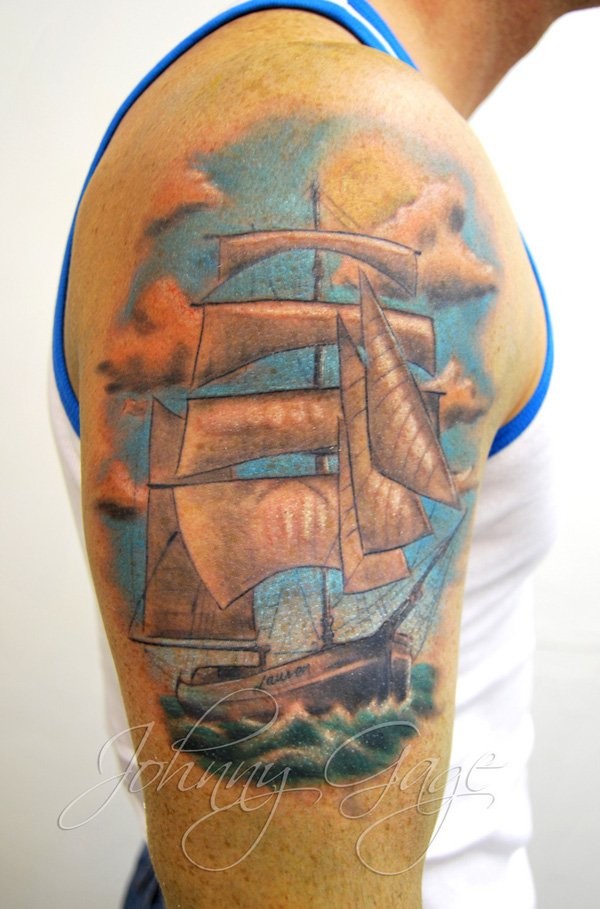 Sweet looking colored shoulder tattoo of awesome sailing ship