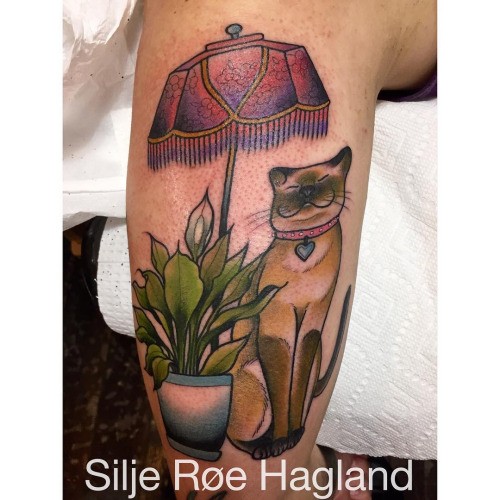 Sweet looking colored tattoo of home cat with lamp and plant