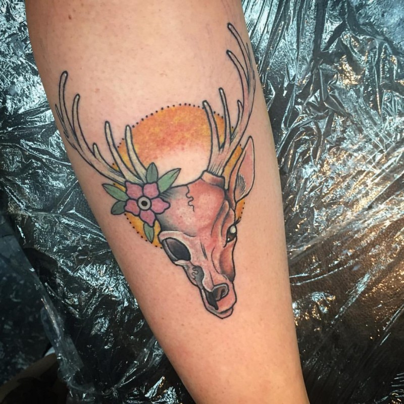 Sweet looking colored tattoo of original looking deers head with flower