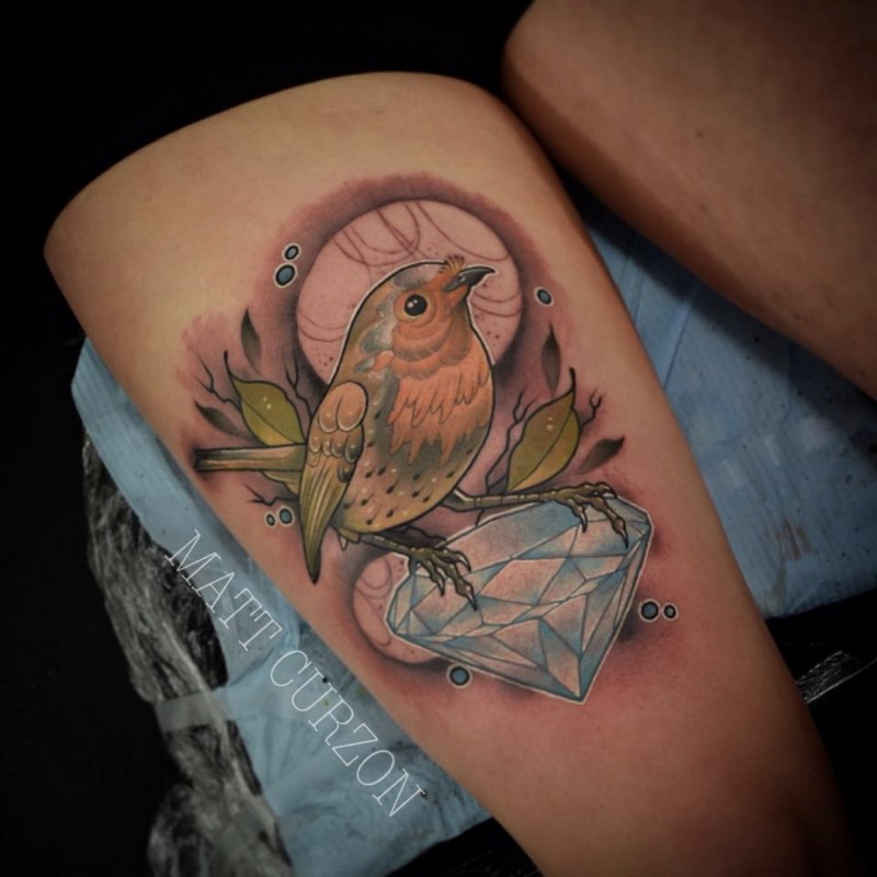 Sweet looking colored thigh tattoo of little bird with blue diamond