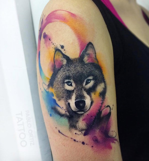 Sweet looking colored upper arm tattoo of wolf