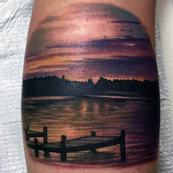 Sweet realistic looking colored lake shore tattoo on leg