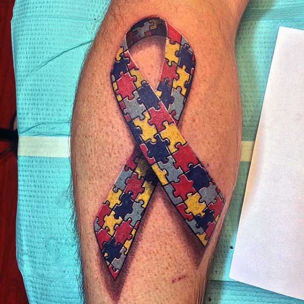 Symbolical multicolored puzzle pieces ribbon tattoo in 3D style