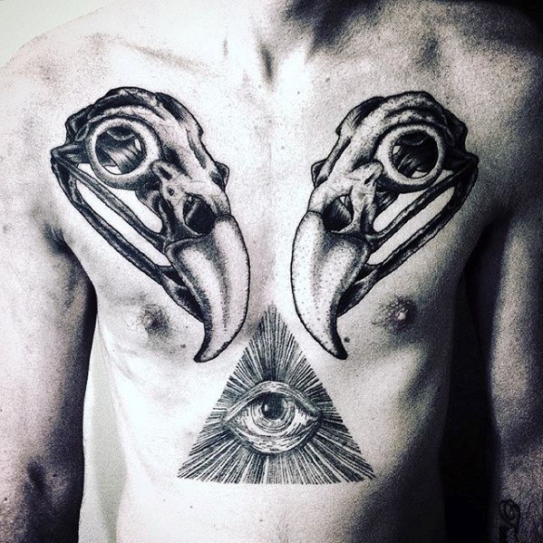 Symmetrical black ink chest tattoo of animal skulls and mystic triangle