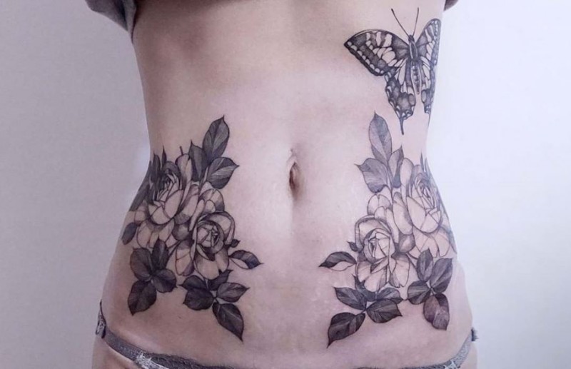 Symmetrical designed by Zihwa belly tattoo of nice roses