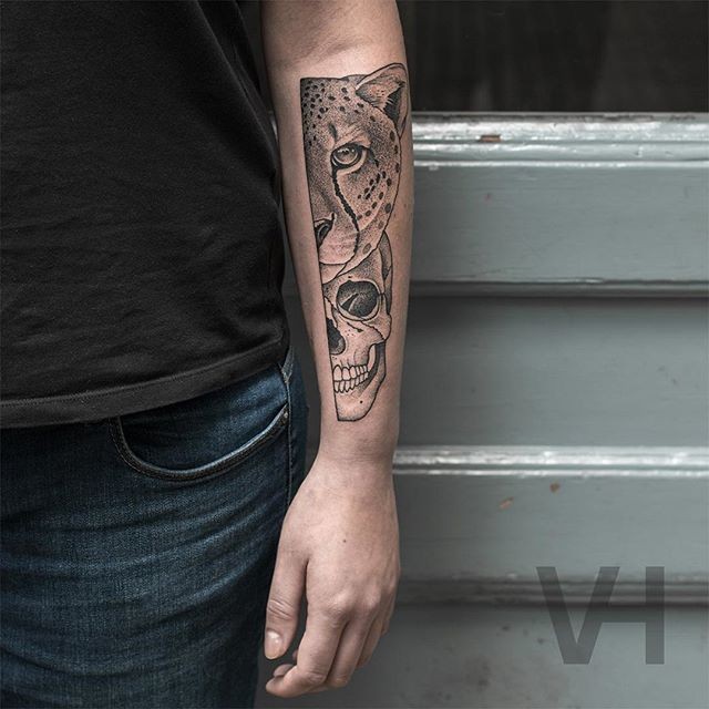 Symmetrical inspired arm tattoo of leopard head with human skull by Valentin Hirsch