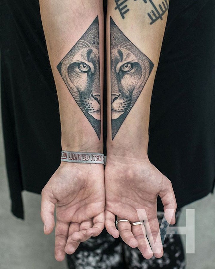 Symmetrical painted arm tattoo of cool cat head by Valentin Hirsch