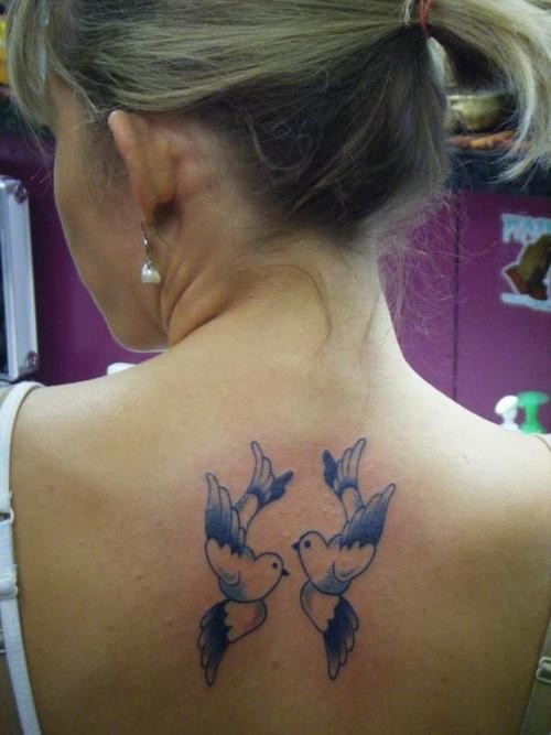 Tattoo with two chinese birds on back